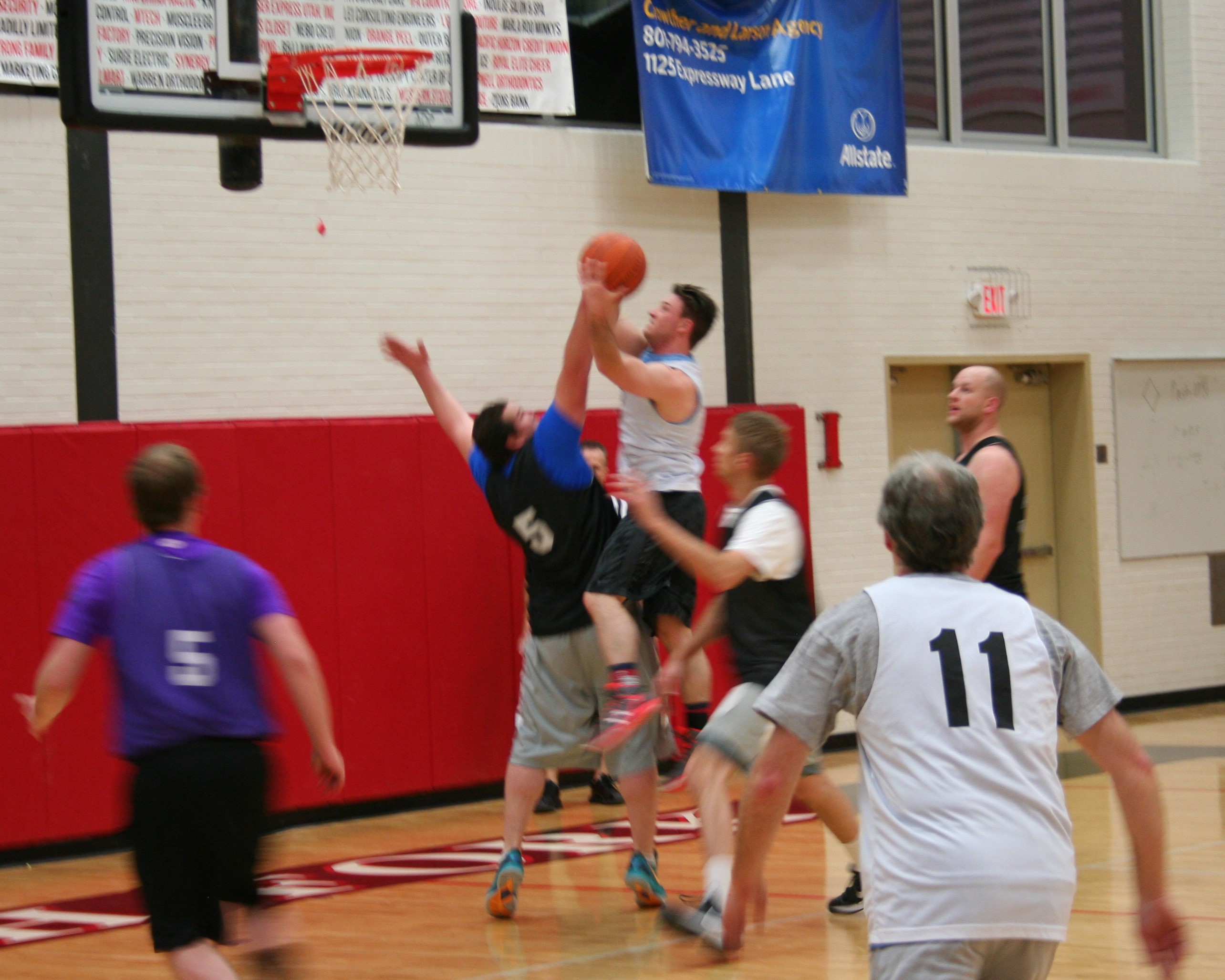 Men playing basketball in gym